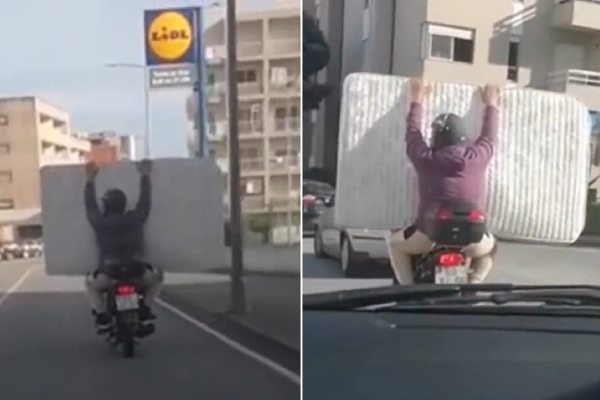 Motociclista e acompanhante transportam colchão numa mota em Viana do Castelo